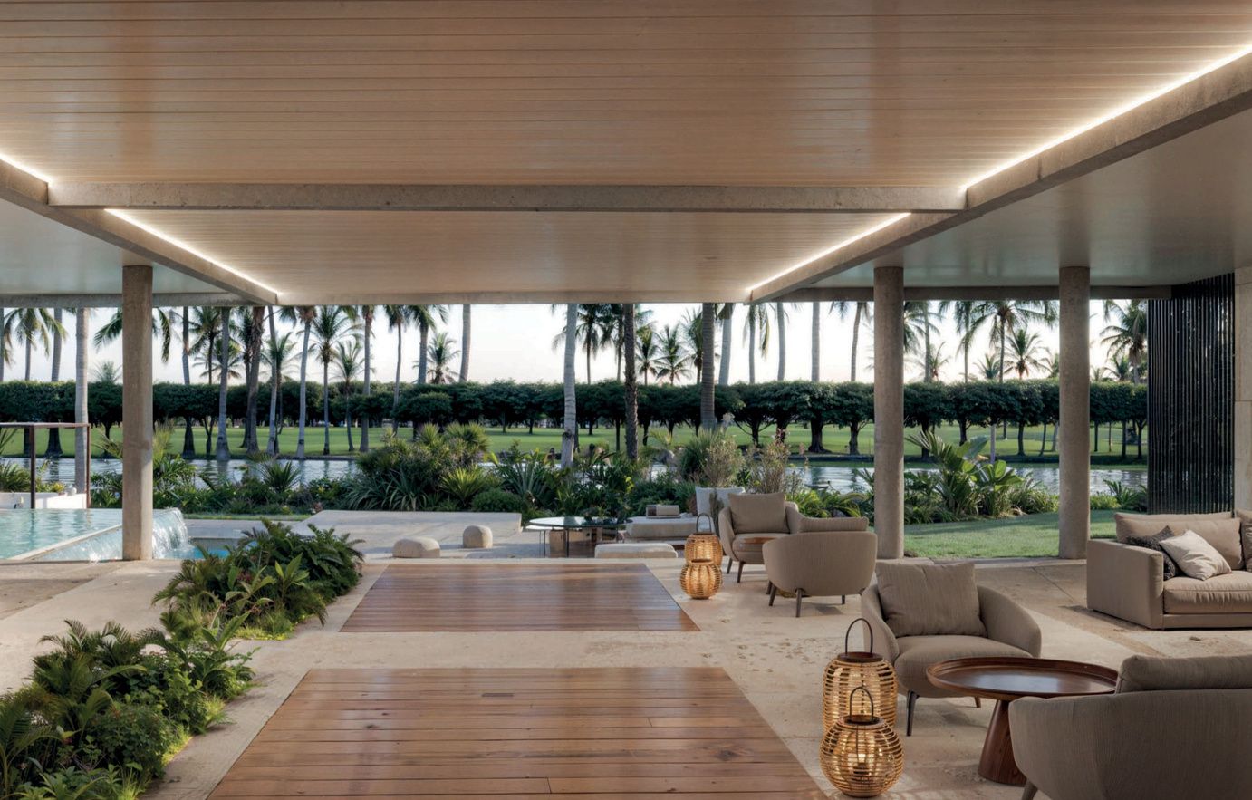 Covered outdoor lounge terrace at Reef and Golf Residences overlooking the golf course, render